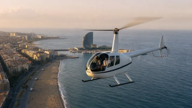Helicopter flying over Barcelona at golden hour with the Sagrada Família in the distance