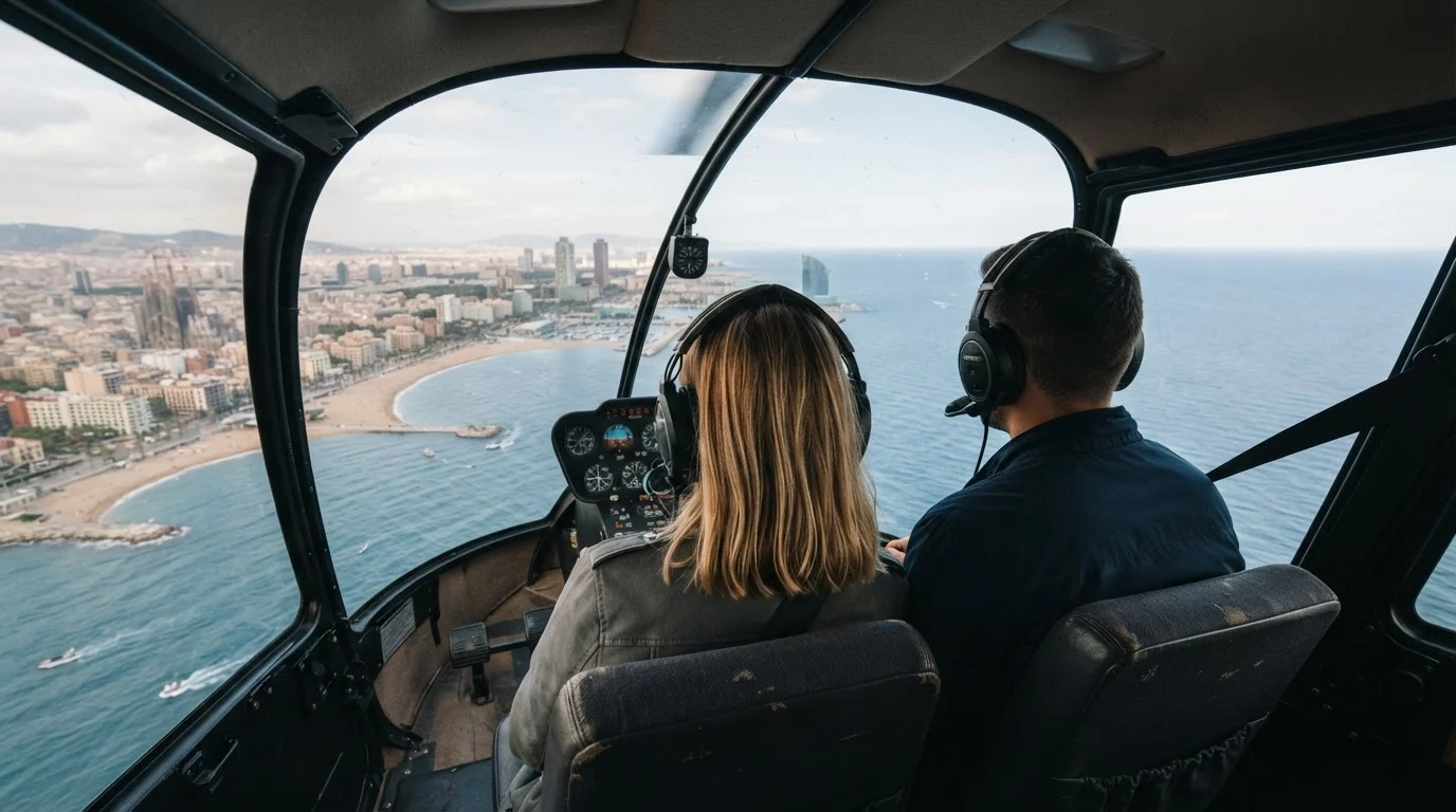A couple seen from behind in a helicopter cabin, looking through the window at the Barcelona coastline and the sea
