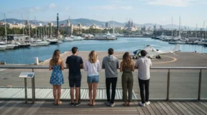 Six friends seen from behind on a harbour terrace in Port Vell, watching a white helicopter parked on the helipad